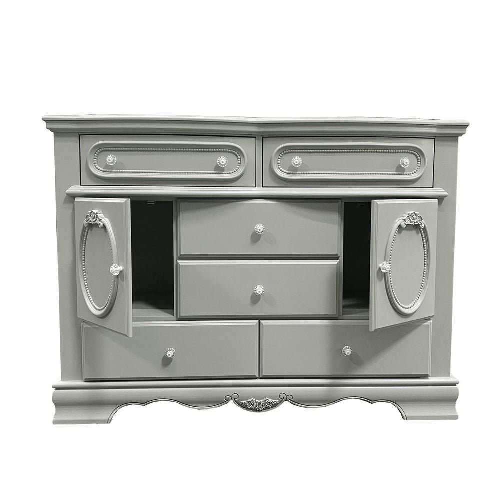 Primrose Gray Dresser with Floral Accent A light gray painted wooden dresser with ornate silver-tone drawer pulls and decorative oval cabinet doors, shown on a plain white background.