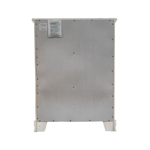 Primrose White Chest with Floral Accent The back view of a stainless steel appliance, likely a refrigerator or freezer, showing the rear panel with mounting holes, a small label near the top left, and white feet at the bottom.