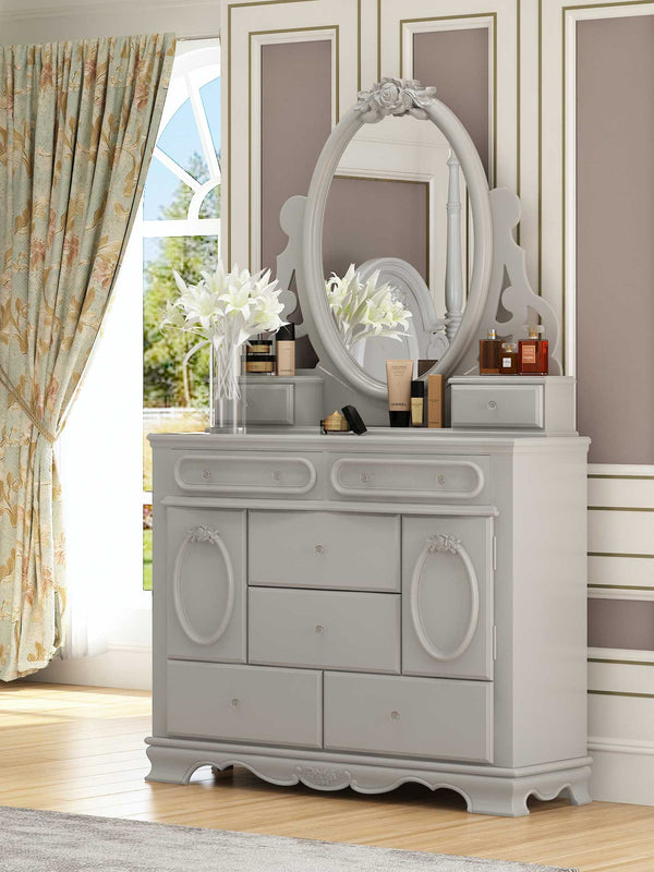 Primrose White Dresser with Floral Accent A light gray painted wooden dresser with an oval mirror, shown in a styled bedroom setting with curtains, a window, and decorative items on top.