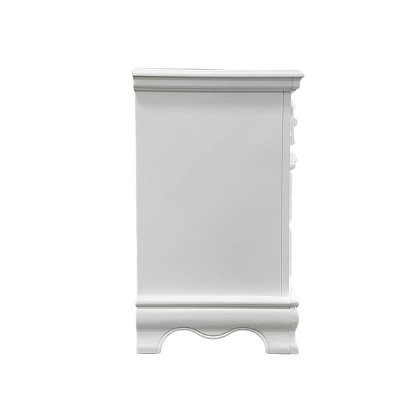 Primrose White Nightstand with Floral Accent A white wooden nightstand or end table with decorative molding and a curved apron, shown from the side against a plain white background.
