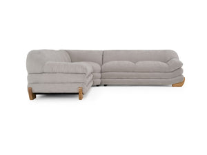 Prinkett Modular Corner Light Gray Sectional Sofa A light gray upholstered sectional sofa with a left-facing chaise and light wood legs, shown against a plain white background.