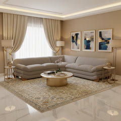 Prinkett Modular Corner Light Gray Sectional Sofa A light gray upholstered sectional sofa with a low-profile, rounded design and natural wood legs, shown from a three-quarters angle on a white background.