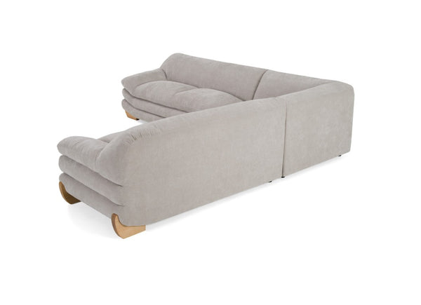 Prinkett Modular Corner Light Gray Sectional Sofa A light gray upholstered sectional sofa with a low, rounded back and natural wood legs, shown from a three-quarters perspective on a white background.