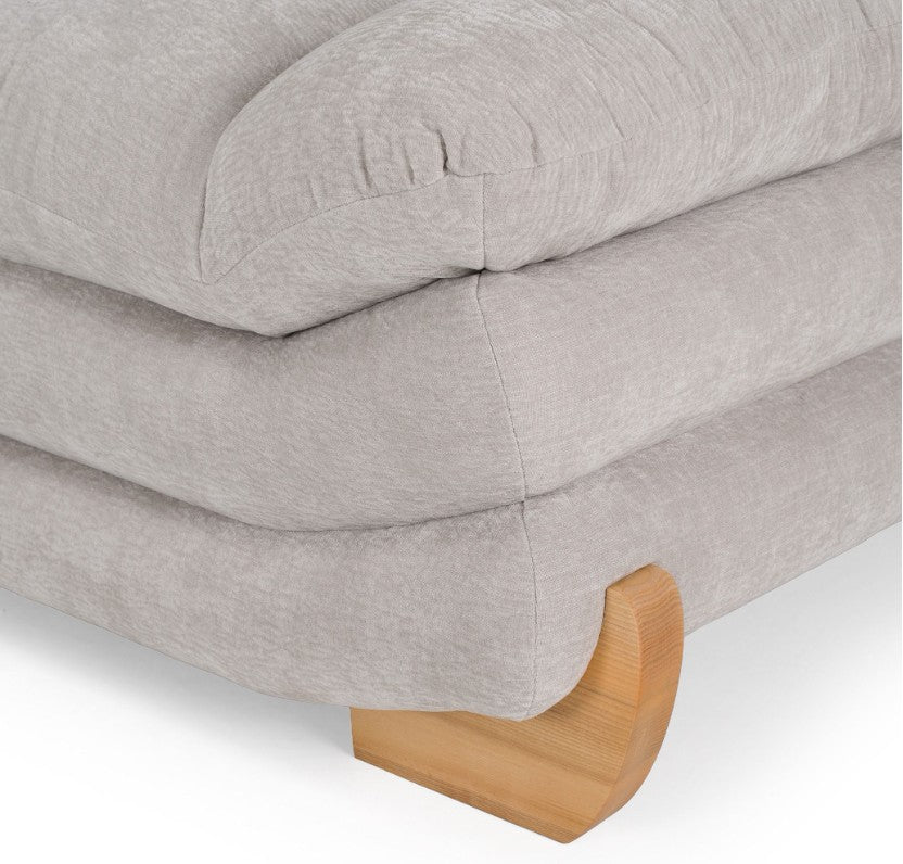 Prinkett Modular Corner Light Gray Sectional Sofa A light gray upholstered sectional sofa with a low-profile, rounded design and natural wood legs, shown from a three-quarters angle on a white background.