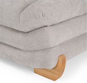 Prinkett Modular Corner Light Gray Sectional Sofa Close-up of a light gray upholstered ottoman or bench with a curved wooden footrest, shown on a white background.