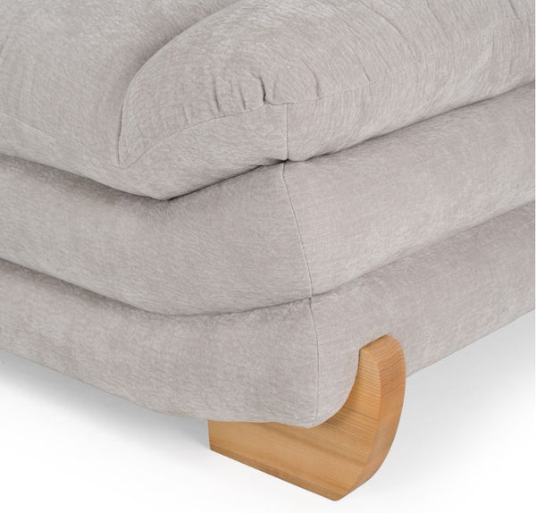 Prinkett Modular Corner Light Gray Sectional Sofa Close-up of a light gray upholstered ottoman or bench with a curved wooden footrest, shown on a white background.