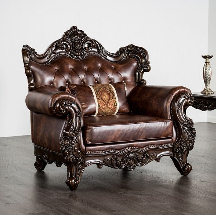 Prisya Traditional Leatherette Rolled Arm Chair Decorative brown leather sofa with intricate carvings in a room.