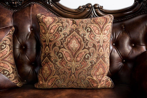 Prisya Traditional Leatherette Rolled Arm Sofa Decorative pillows with intricate patterns on a brown leather sofa