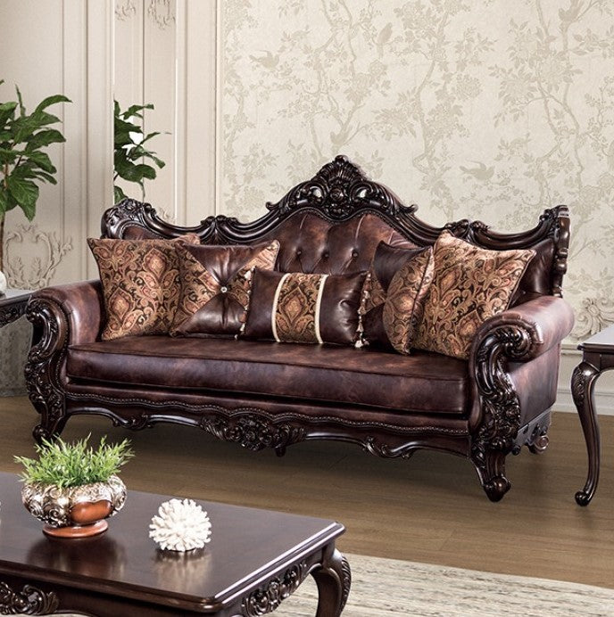 Prisya Traditional Leatherette Rolled Arm Sofa Decorative brown leather sofa with intricate carvings in a living room setting.