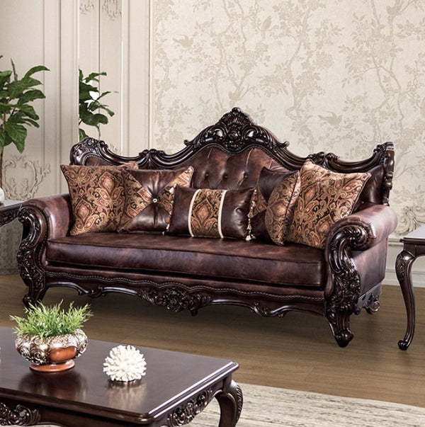 Prisya Traditional Leatherette Rolled Arm Sofa Decorative brown leather sofa with intricate carvings in a living room setting.
