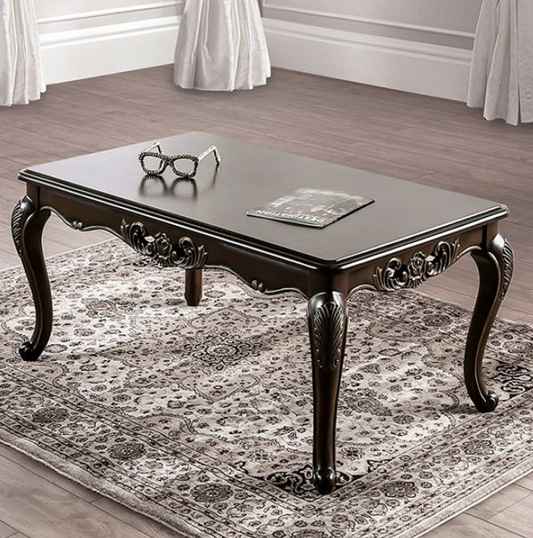 Prisya Traditional Solid Wood Coffee Table Decorative dark wood coffee table with intricate carvings on a patterned rug.