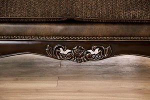 Priya Leatherette Fabric Button Tufted Sofa Close-up of a decorative armchair with intricate carvings on a wooden floor.