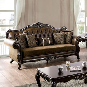 Priya Leatherette Fabric Button Tufted Sofa Luxurious brown leather sofa with decorative pillows in a living room setting.