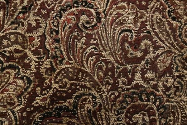 Priya Leatherette Fabric Button Tufted Sofa Close-up of a patterned fabric with intricate designs in brown and beige.