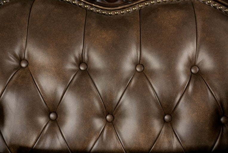 Priya Leatherette Fabric Button Tufted Sofa Luxurious brown leather sofa with decorative pillows in a living room setting.