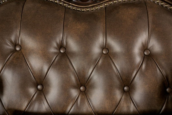 Priya Leatherette Fabric Button Tufted Sofa Close-up of a brown leather sofa with tufted backrest