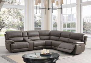 Punge Power Motion Reclining Sectional Sofa Gray sectional sofa in a living room with large windows.