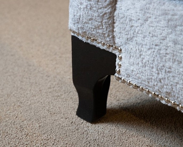 Risha Sloped Arm Light Gray Sofa Close-up of a textured surface with a black object partially visible
