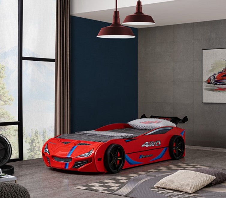 Robin High Gloss Race Car Bed With Trundle Closed in Red Red car-shaped bed in a modern bedroom with gray walls and large windows.