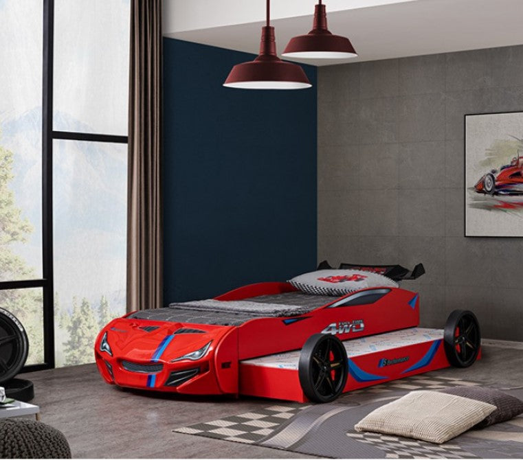 Robin High Gloss Race Car Bed With Trundle Closed in Red Red car-shaped bed in a modern bedroom with gray walls and large windows.