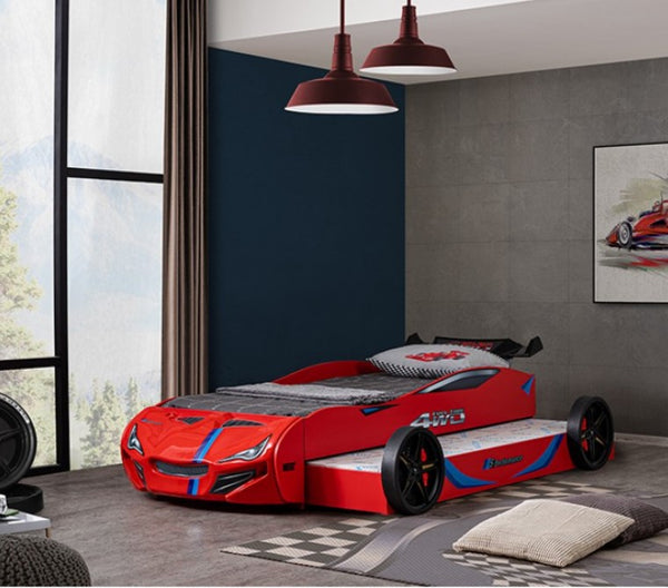 Robin High Gloss Race Car Bed With Trundle Closed in Red Red car-shaped bed in a modern bedroom with large windows and decorative elements.