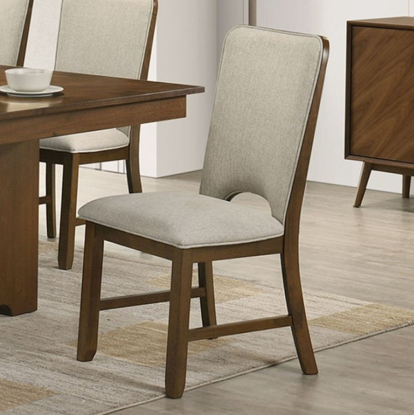 Saharia Mid-Century Modern Walnut Dining Chair A wooden dining chair with a light beige upholstered seat and back cushion, shown in a dining room setting next to a wooden table.