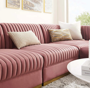 Sanchi 4PC Channel Tufted Velvet Modular Sectional Sofa Rose Pink sectional sofa with decorative pillows in a living room setting