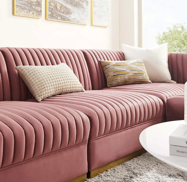 Sanchi 4PC Channel Tufted Velvet Modular Sectional Sofa Rose Pink sectional sofa with decorative pillows in a living room setting