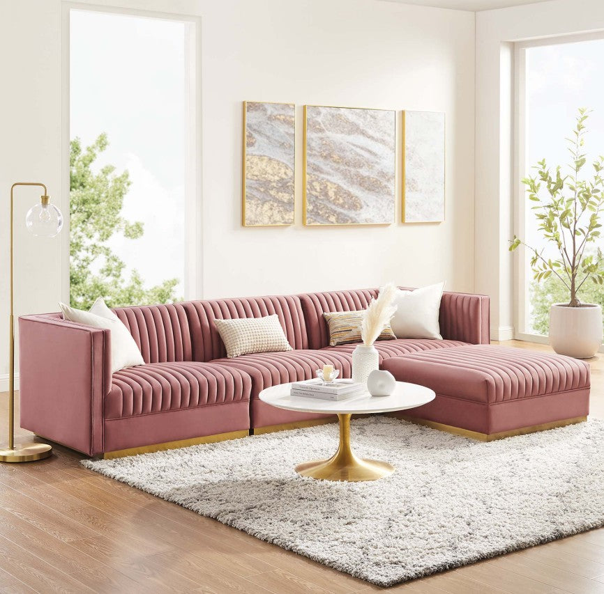 Sanchi 4PC Channel Tufted Velvet Modular Sectional Sofa Rose Pink sectional sofa in a living room with a white coffee table and decorative elements.