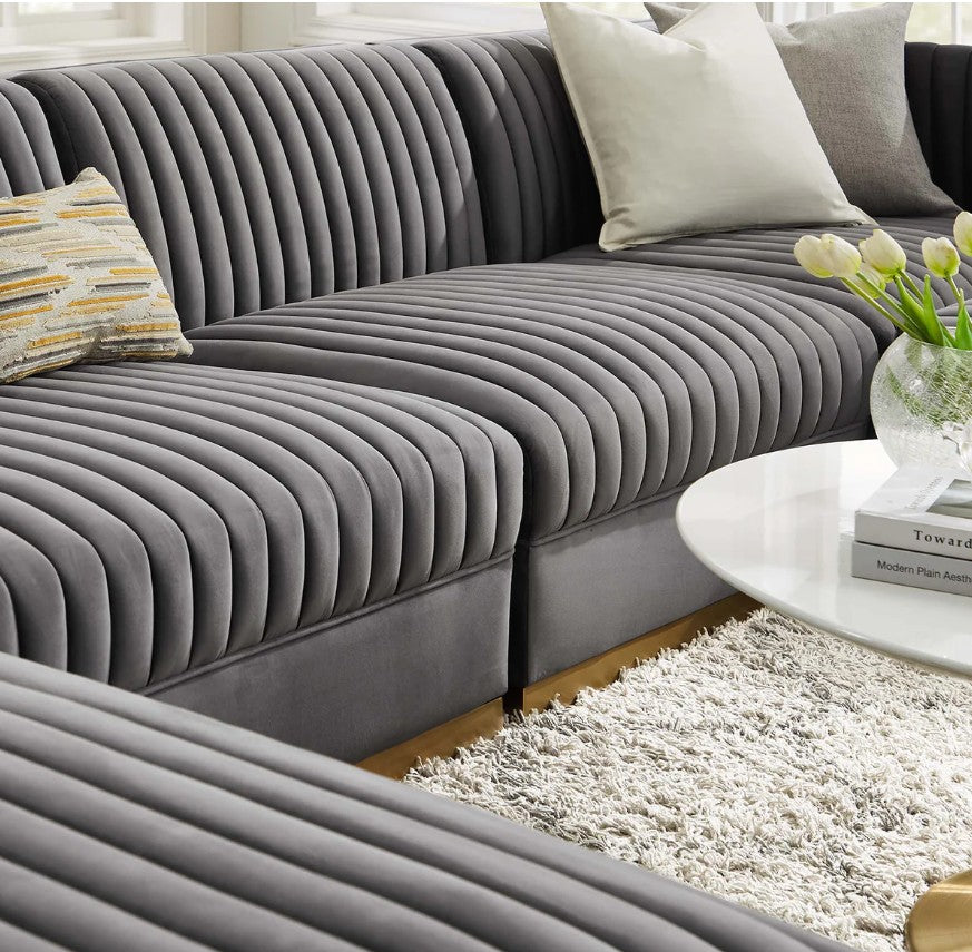 Sanchi 6PC Channel Tufted Velvet Modular Sectional Sofa Gray Modern living room with a gray sectional sofa, coffee table, and abstract art on the wall.