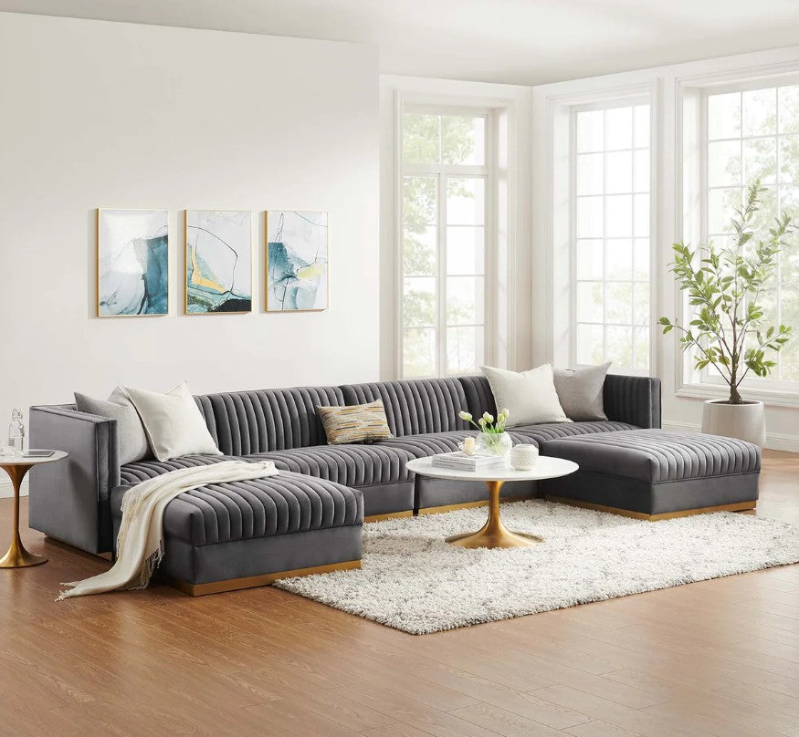 Sanchi 6PC Channel Tufted Velvet Modular Sectional Sofa Gray Modern living room with a gray sectional sofa, coffee table, and abstract art on the wall.
