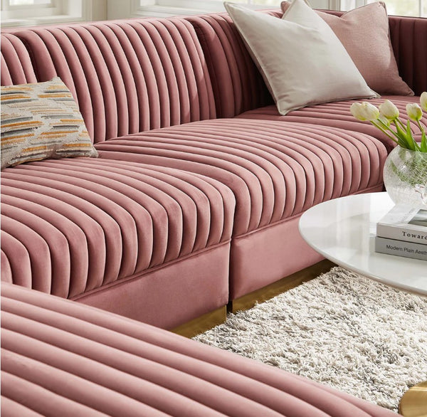 Sanchi 6PC Channel Tufted Velvet Modular Sectional Sofa Rose Pink ribbed sofa with decorative pillows in a living room setting.