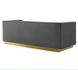 Sanchi Vertical Channel Tufted Velvet Sofa Gray Modern reception desk with black surface and gold base on a white background