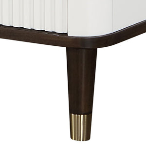 Serania Two Tone Chest Close-up of a wooden leg with a brass cap on a white background
