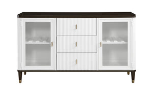 Serania Two Tone Dining Server A white sideboard cabinet with a dark brown top and legs, featuring three central drawers with vertical fluting and two glass-front doors on the sides, accented with small gold handles.