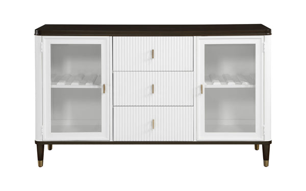 Serania Two Tone Dining Server A white sideboard cabinet with a dark brown top and legs, featuring three central drawers with vertical fluting and two glass-front doors on the sides, accented with small gold handles.
