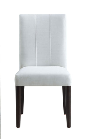 Serania Two Tone Dining Table Chair An upholstered dining chair with a tall, vertically channel-tufted backrest and a padded seat, upholstered in a light gray fabric with dark brown wooden legs, shown against a plain white background.