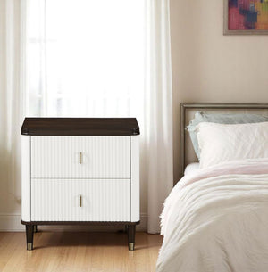 Serania Two Tone Nightstand White nightstand with dark wood top next to a bed in a bedroom.