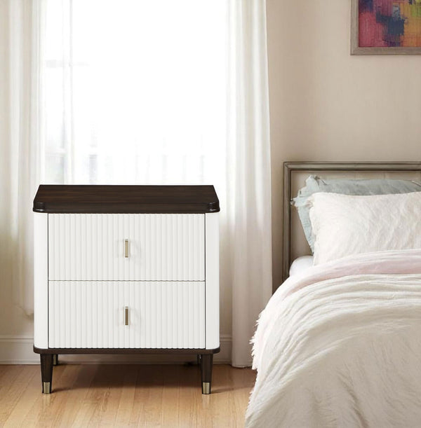 Serania Two Tone Nightstand White nightstand with dark wood top next to a bed in a bedroom.