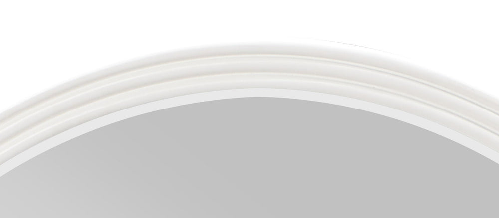 Serania Two Tone Wall Mirror Round mirror on a wall above a dresser with various bottles and a plant.
