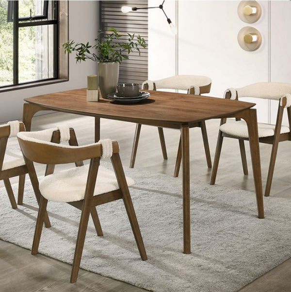 Mid Century Modern Walnut Dining Table Dining room with wooden table and chairs on a rug A modern dining room scene featuring a rectangular wooden table with four matching armchairs that have light beige woven seats and backs, arranged on a light gray rug.