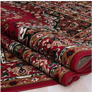 Shotta Traditional Style 5x8 Red Area Rug Roll of patterned red and brown fabric