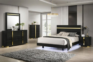 Shysko Black Gold Contemporary Style Chest A modern bedroom furniture set featuring a black bed frame with gold accents, a matching dresser with a mirror, a tall chest, and a nightstand, styled in a contemporary bedroom with gray walls and wood flooring.