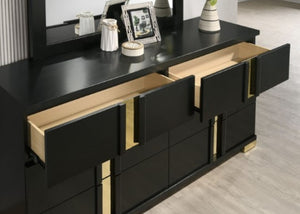 Shysko Black Gold Contemporary Style Dresser A modern black wooden dresser with multiple drawers, some open to reveal light wood interiors, accented with gold-tone handles and feet. A matching black mirror sits on top, styled with small decorative objects, against a light wood floor.