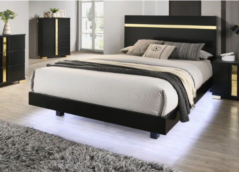 Shysko Black Gold LED Contemporary Style Bed A modern bedroom furniture set featuring a black bed frame with gold trim, a matching black nightstand, a black dresser with a mirror, and a black chest, all styled in a contemporary bedroom with gray walls and wood flooring.