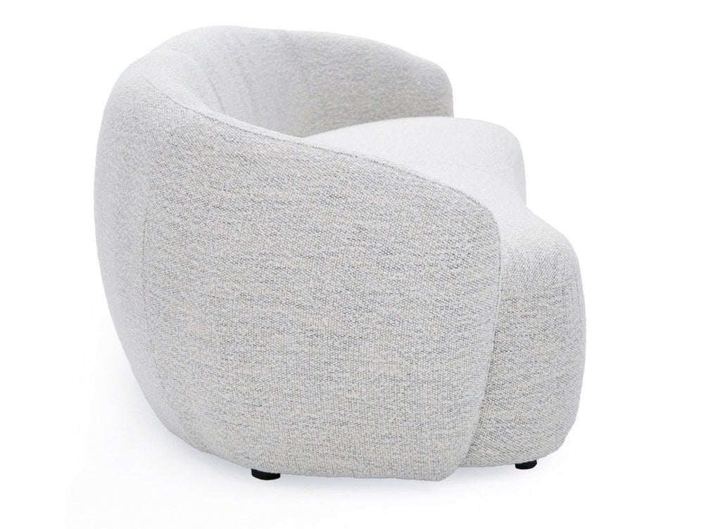 Silvi Off White Modern Fabric Sofa Modern beige sofa in a minimalistic living room with a large window.