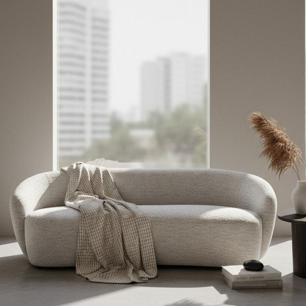 Silvi Off White Modern Fabric Sofa Modern beige sofa in a minimalistic living room with a large window.
