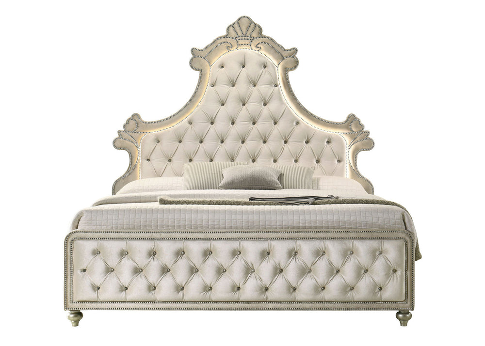 Luxury bedroom set with tufted bed, dressers, and mirror in a well-lit room.