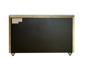 Sonya Beige Velvet Upholstered Traditional Style Dresser A rectangular black board or panel with a metallic gold-toned frame, shown against a plain white background. Small labels are attached in the upper left corner, and small metallic feet or supports are visible at the bottom corners.