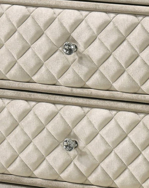 Sonya Beige Velvet Upholstered Traditional Style Dresser Close-up of a quilted cream-colored dresser drawer front with a diamond pattern and a round silver-tone knob.